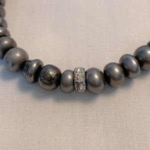 Adjustable pewter beaded bracelet with crystal spacers.